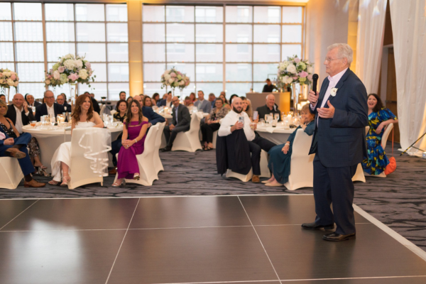 Father of the bride giving a heartfelt wedding speech during the reception.